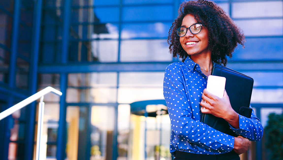 Businesswoman wearing polka dot blouse standing outside 