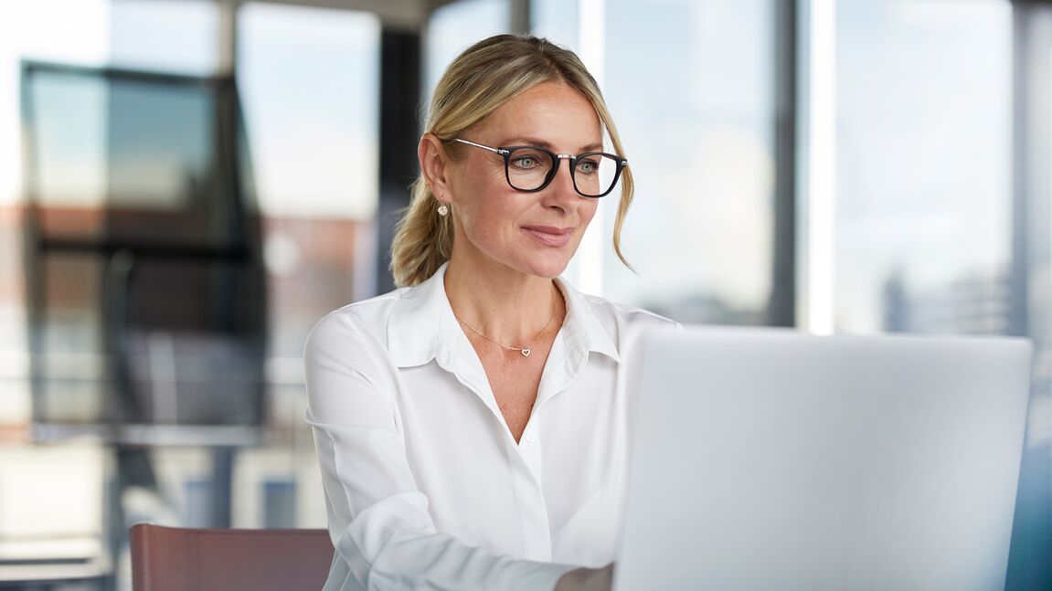 Businesswoman working on laptop in modern office