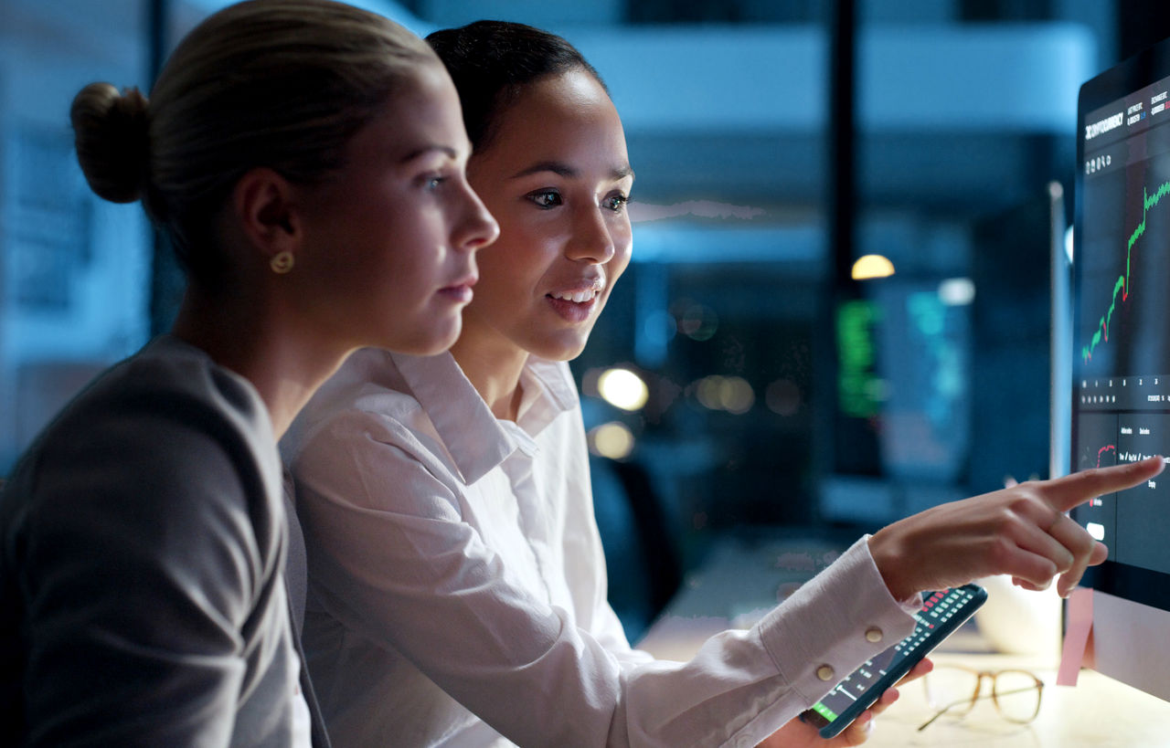 Two colleagues looking at computer screen