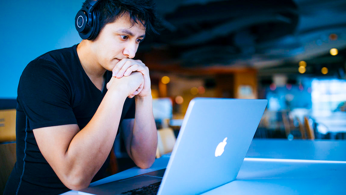 Man with headphones looking at laptop