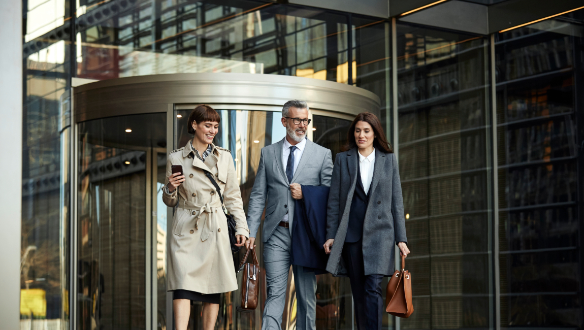 Three colleagues leaving office building together