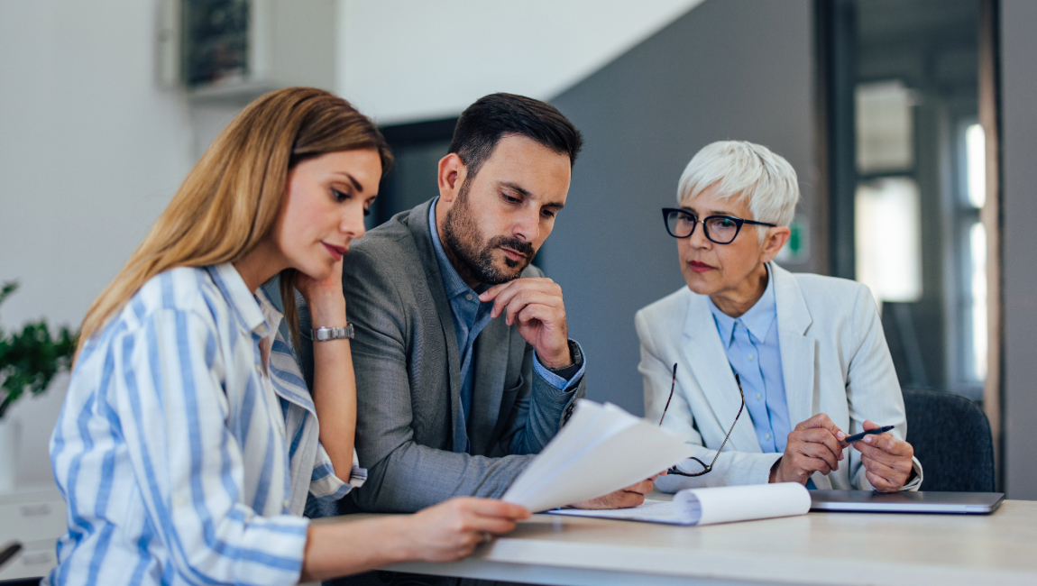 Three colleagues looking over paperwork