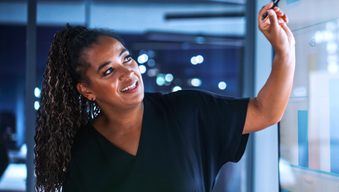 Business woman pointing at interactive screen