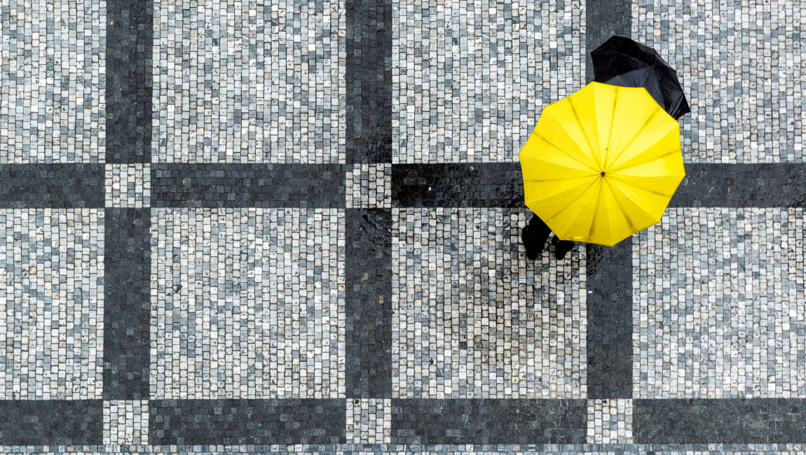 Aerial view of person holding yellow umbrella