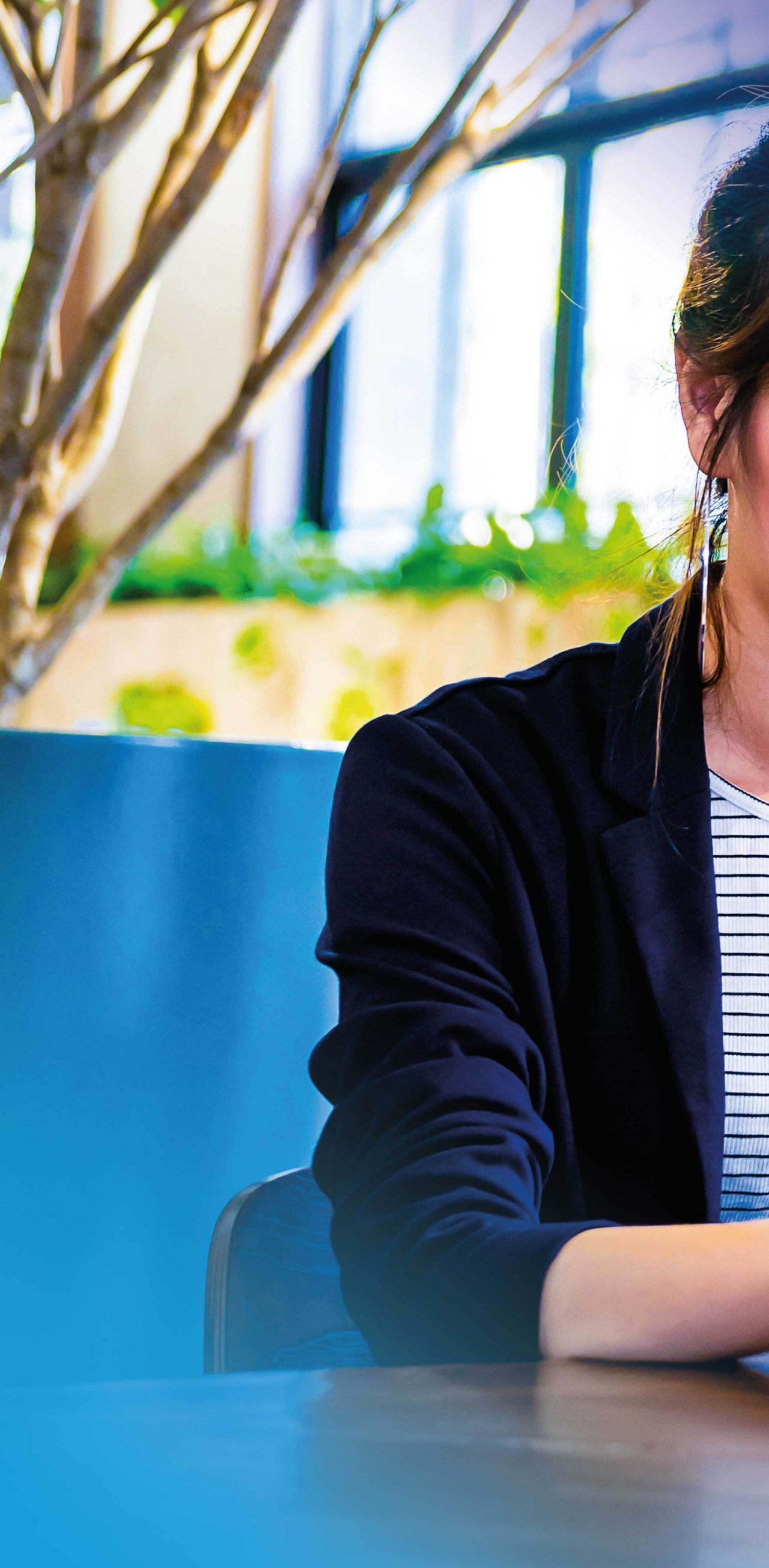 Image mosaic of smiling woman working on laptop