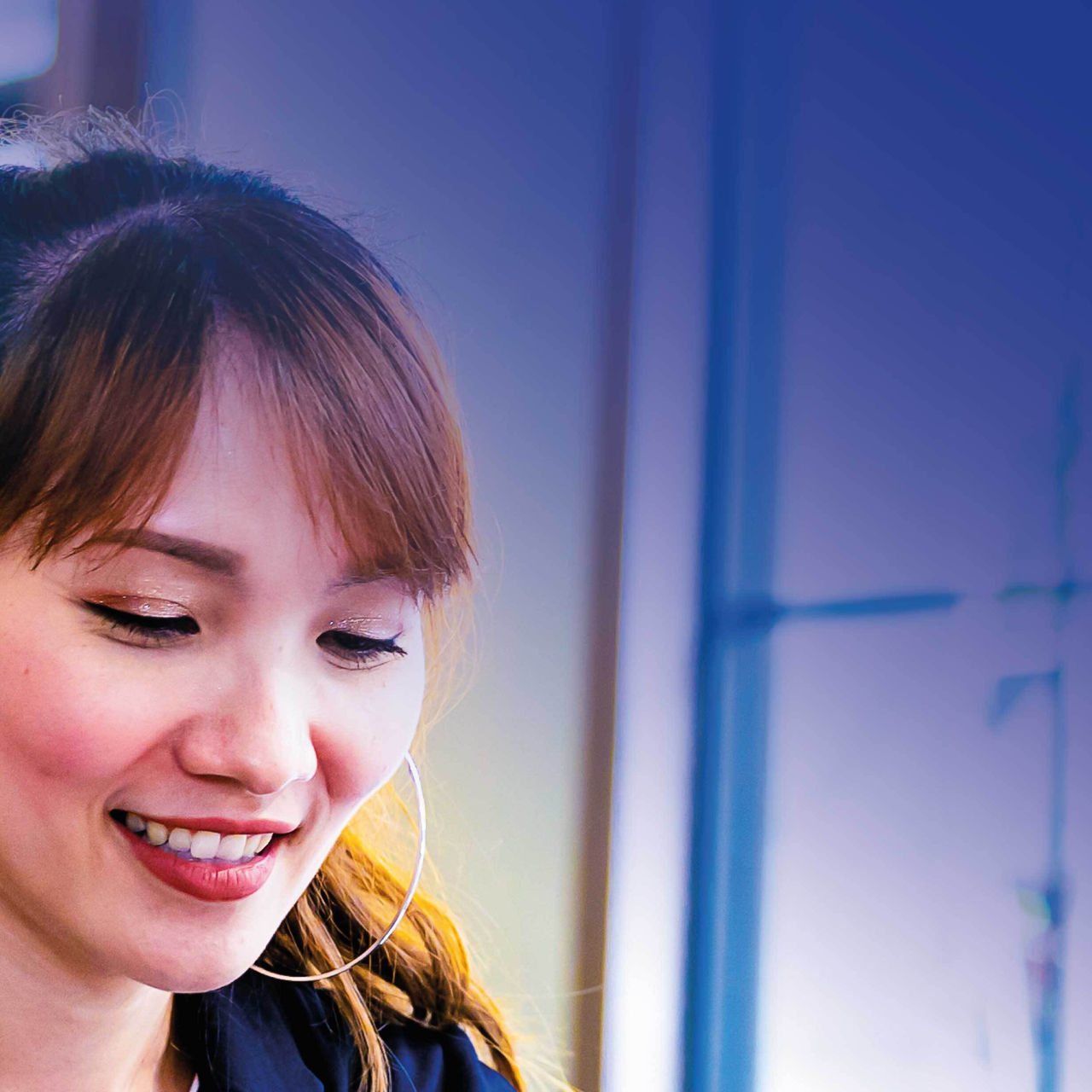 Continuation of image mosaic of smiling woman working on laptop