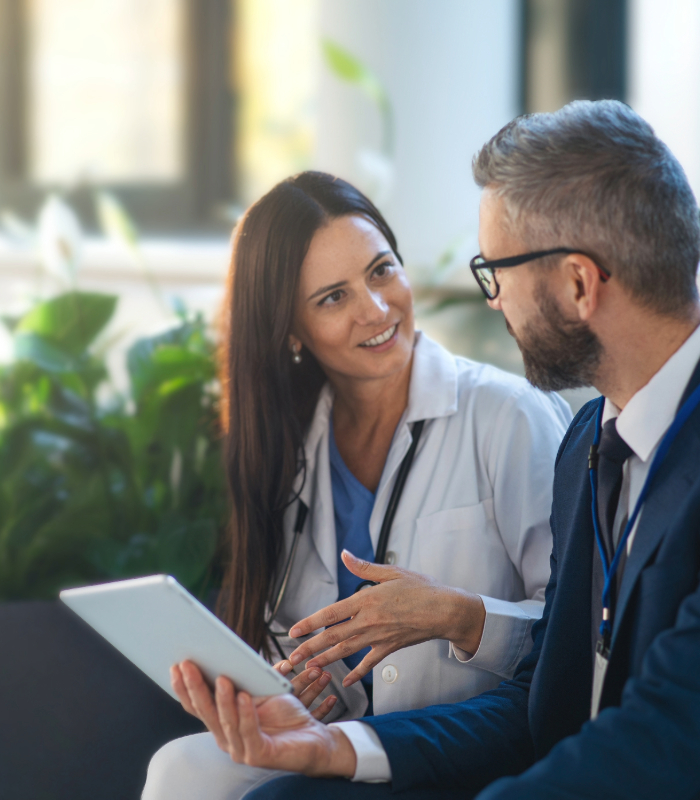 Two people chatting during a convention while holding tablet